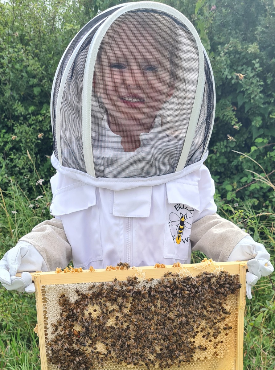 Millie holding a bee frame